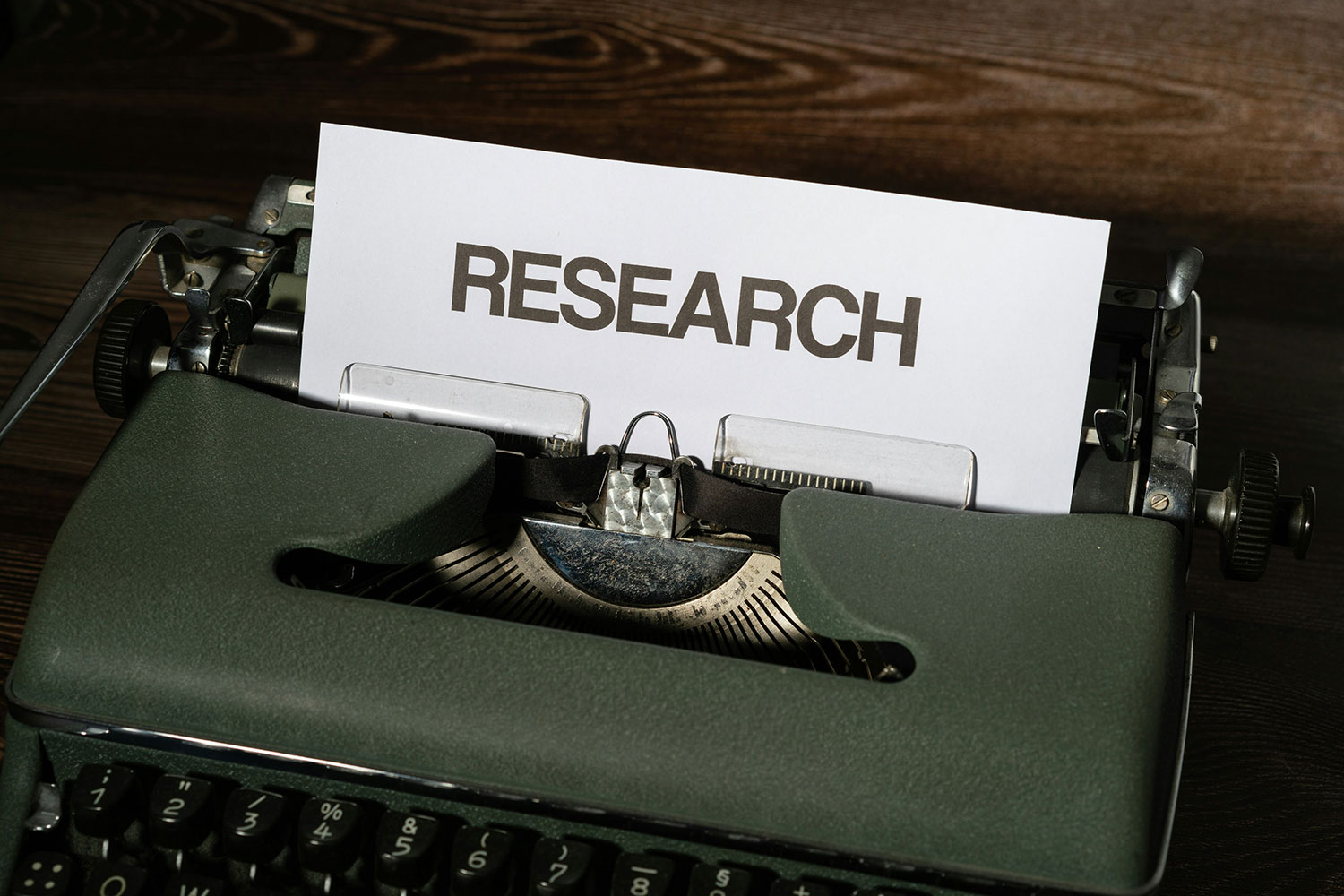 typewriter and sheet of paper with the word Research