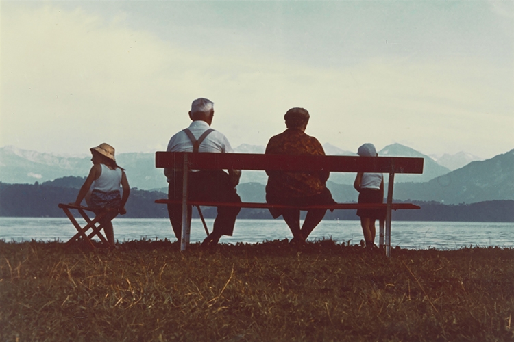 Dettaglio della locandina: persone sedute su una panchina viste di spalle